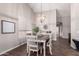 Cozy dining area with stylish light fixture, wood floors, and seating for six at 9717 E Holiday Way, Sun Lakes, AZ 85248