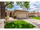Inviting single-story home featuring a well-kept lawn and a convenient two-car garage at 9717 E Holiday Way, Sun Lakes, AZ 85248