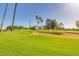 Experience scenic views of the lush golf course with mature landscaping and bright blue skies at 9717 E Holiday Way, Sun Lakes, AZ 85248