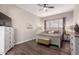 Relaxing bedroom with ceiling fan, wood floors, and an accent wall at 9717 E Holiday Way, Sun Lakes, AZ 85248
