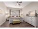 Tranquil bedroom offers soft lighting, neutral tones, and hardwood flooring at 9717 E Holiday Way, Sun Lakes, AZ 85248