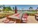 Inviting patio with a fire pit table and scenic views of a pond and a golf course at 9717 E Holiday Way, Sun Lakes, AZ 85248