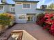 Private backyard with brick paving and flowering bushes at 10101 N 91St Ave # 162, Peoria, AZ 85345