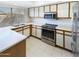 Modern kitchen with stainless steel appliances and white countertops at 10101 N 91St Ave # 162, Peoria, AZ 85345