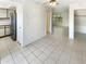 Open-concept living room with tile flooring, view to the kitchen and a sunroom at the back of the home at 10101 N 91St Ave # 162, Peoria, AZ 85345