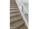 Carpeted staircase with white railing provides access to the upper level of the home at 10101 N 91St Ave # 162, Peoria, AZ 85345