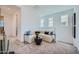 Open living area with plush carpeting, a comfortable sectional, and plenty of natural light from the nearby windows at 10152 E Ursula Ave, Mesa, AZ 85212