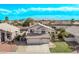 Aerial view of a charming home with a three-car garage, landscaped yard, and a well-manicured lawn at 11317 W Cottonwood Ln, Avondale, AZ 85392
