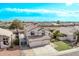Residential area aerial view of a Gathering home featuring a three-car garage and landscaped backyard at 11317 W Cottonwood Ln, Avondale, AZ 85392