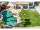 Aerial view of the backyard with a pool, patio, and small grassy area at 11317 W Cottonwood Ln, Avondale, AZ 85392