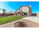 Spacious backyard featuring a well-maintained lawn, covered patio, firepit, and block fence for privacy at 11317 W Cottonwood Ln, Avondale, AZ 85392