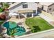 Aerial shot showcases the backyard, featuring a pristine pool, covered patio, and green space at 11317 W Cottonwood Ln, Avondale, AZ 85392
