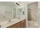 Bright bathroom featuring double sinks, a large mirror, and a tiled shower/tub combination at 11317 W Cottonwood Ln, Avondale, AZ 85392