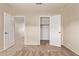 Bedroom with sliding closet doors and neutral carpeting. View to hallway at 11317 W Cottonwood Ln, Avondale, AZ 85392