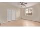 Bedroom featuring tile floors, ceiling fan, closet and window providing natural light at 11317 W Cottonwood Ln, Avondale, AZ 85392