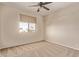 Comfortable bedroom with ceiling fan and neighborhood views from the window at 11317 W Cottonwood Ln, Avondale, AZ 85392