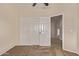 Bedroom with sliding closet doors and attached open bathroom at 11317 W Cottonwood Ln, Avondale, AZ 85392