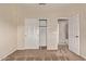 Neutral carpeted bedroom with a closet and doors to the rest of the home at 11317 W Cottonwood Ln, Avondale, AZ 85392