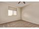 Bedroom featuring neutral walls and carpeting and a window with blinds at 11317 W Cottonwood Ln, Avondale, AZ 85392