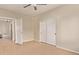 Bedroom featuring tile floors, ceiling fan, and closet. View to hallway at 11317 W Cottonwood Ln, Avondale, AZ 85392