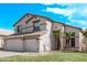 Two-story home featuring a three-car garage, neutral stucco, and desert-friendly landscaping at 11317 W Cottonwood Ln, Avondale, AZ 85392