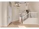 Bright foyer with high ceilings, tile flooring, staircase, and modern chandelier at 11317 W Cottonwood Ln, Avondale, AZ 85392