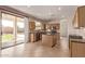 Stylish kitchen features island, granite countertops, custom cabinets and stainless steel appliances at 11317 W Cottonwood Ln, Avondale, AZ 85392