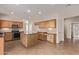 Open kitchen featuring a large island with bar seating, granite countertops, stainless steel appliances and ample storage at 11317 W Cottonwood Ln, Avondale, AZ 85392