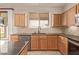 Well-lit kitchen with custom cabinets, stainless steel appliances, granite countertops and an island at 11317 W Cottonwood Ln, Avondale, AZ 85392