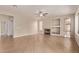 Open living room featuring tile flooring, fireplace, and a ceiling fan to keep you cool in this bright, open space at 11317 W Cottonwood Ln, Avondale, AZ 85392