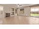 Spacious living room includes tile flooring, fireplace, window, and sliding glass door leading to backyard at 11317 W Cottonwood Ln, Avondale, AZ 85392