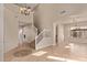 Open-concept living area featuring tile floors and an elegant staircase at 11317 W Cottonwood Ln, Avondale, AZ 85392