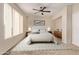 Calm bedroom featuring neutral colors, large windows, and a comfortable king-size bed at 11317 W Cottonwood Ln, Avondale, AZ 85392