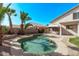 Inviting backyard oasis featuring a sparkling pool, lush tropical landscaping, and a relaxing covered patio at 11317 W Cottonwood Ln, Avondale, AZ 85392