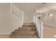 Carpeted staircase features white railing leading to upper level living space at 11317 W Cottonwood Ln, Avondale, AZ 85392