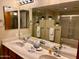 Bathroom featuring a double vanity with cultured marble countertops and a large framed mirror at 12222 N Paradise Village Pkwy # 321, Phoenix, AZ 85032