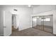 Bright bedroom featuring mirrored closet doors, neutral carpeting, and a ceiling fan at 13811 N 42Nd Pl, Phoenix, AZ 85032