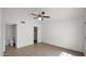 This naturally lit bedroom offers tile flooring, a ceiling fan, and convenient access to an en-suite bathroom at 13811 N 42Nd Pl, Phoenix, AZ 85032