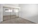 Bright bedroom featuring mirrored closet doors and neutral carpeting at 13811 N 42Nd Pl, Phoenix, AZ 85032