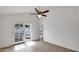 Bright bedroom featuring tile floors, a ceiling fan, and direct access to the outdoor space through sliding glass doors at 13811 N 42Nd Pl, Phoenix, AZ 85032
