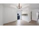 Dining room with chandelier and view into kitchen, ample natural light at 13811 N 42Nd Pl, Phoenix, AZ 85032