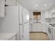 Well-lit kitchen with white cabinets and modern appliances for convenience at 13811 N 42Nd Pl, Phoenix, AZ 85032