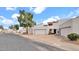 View of a charming white stucco home with a spacious two-car garage and well-maintained landscaping at 13811 N 42Nd Pl, Phoenix, AZ 85032
