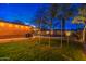 Green backyard with a trampoline and outdoor lighting, perfect for Gathering fun and relaxation at 1402 E Granada Rd, Phoenix, AZ 85006