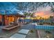 Backyard showcasing covered patio, lush landscaping, and relaxing outdoor living area at 1402 E Granada Rd, Phoenix, AZ 85006