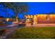 Backyard with a covered patio, outdoor seating, fire pit, and a well-manicured lawn at 1402 E Granada Rd, Phoenix, AZ 85006