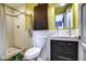 Bright bathroom features a modern vanity, toilet, and shower with decorative towel rack at 1402 E Granada Rd, Phoenix, AZ 85006