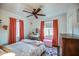 Bright bedroom offers a vanity, a bed with pink accents, and hardwood floors at 1402 E Granada Rd, Phoenix, AZ 85006