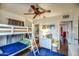 Bright bedroom features a bunk bed, hardwood floors, and closet storage at 1402 E Granada Rd, Phoenix, AZ 85006
