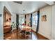 Inviting dining area with a wooden table, stylish lighting, and a view into the cozy living room at 1402 E Granada Rd, Phoenix, AZ 85006